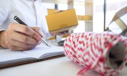 Young entrepreneur business owner work at home, small business startup receive order client and take note working with report and pack the product on purchase delivery online to sending destination.